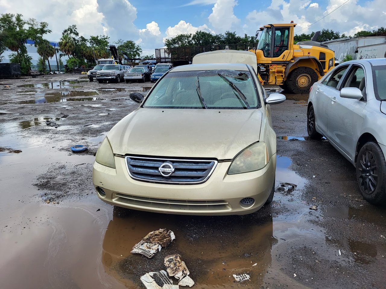 A non-running sedan waiting in our Louisville salvage yard